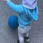 Child under 2 playing with a ball