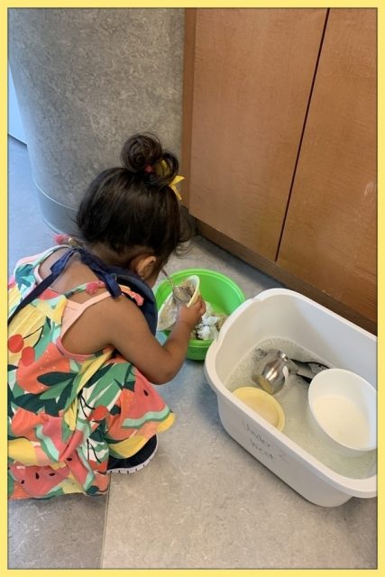 Child under 2 scraping her bowl