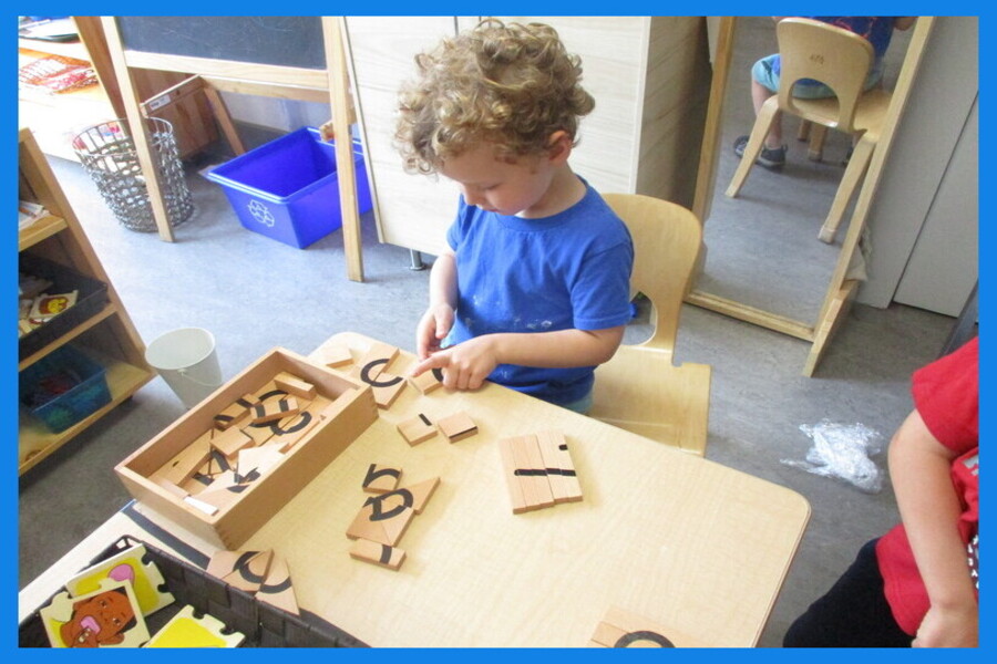 A child working on a wooden number puzzle