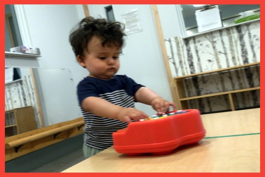 Child playing a toy piano
