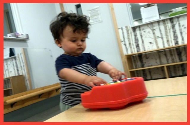 Child playing a toy piano
