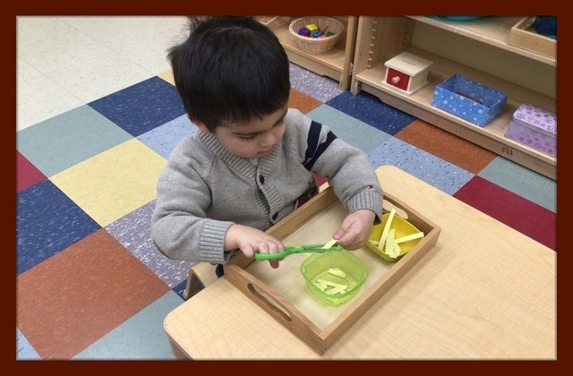 Child under 3 cutting paper with scissors