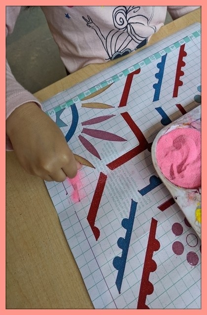 Casa child working on a rangoli art