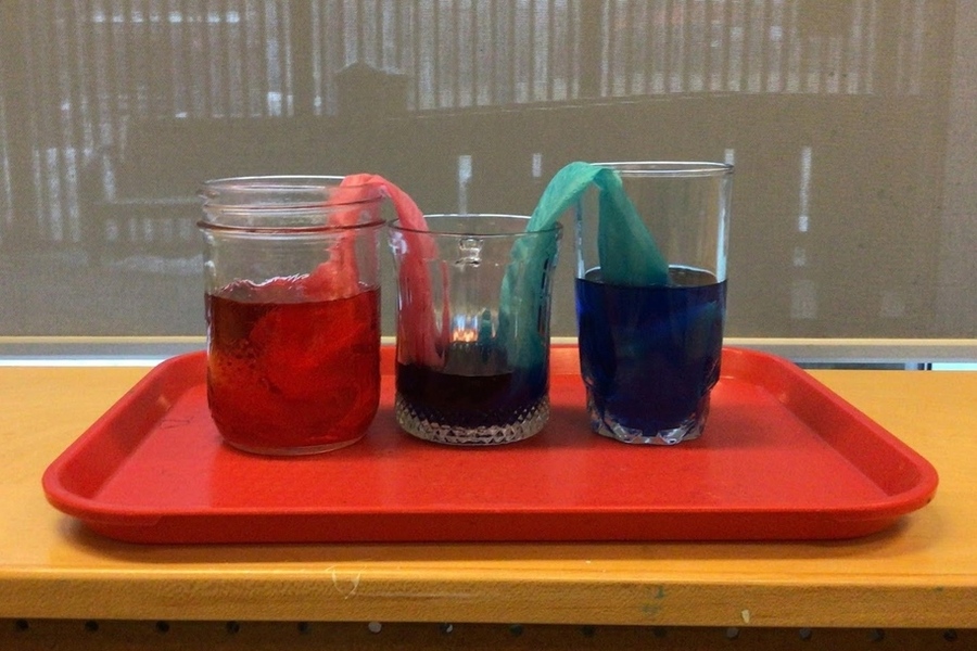 Coloured water starts filling into the middle glass