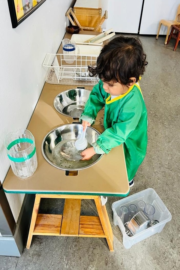 A child washing dishes