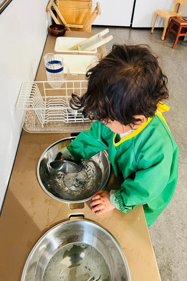 A child washing dishes