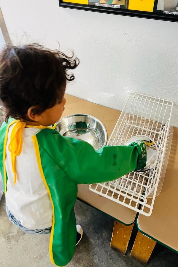 A child washing dishes