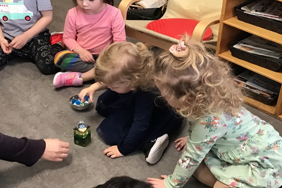 Children closely observing liquids
