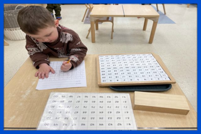 Casa child working on hundred board