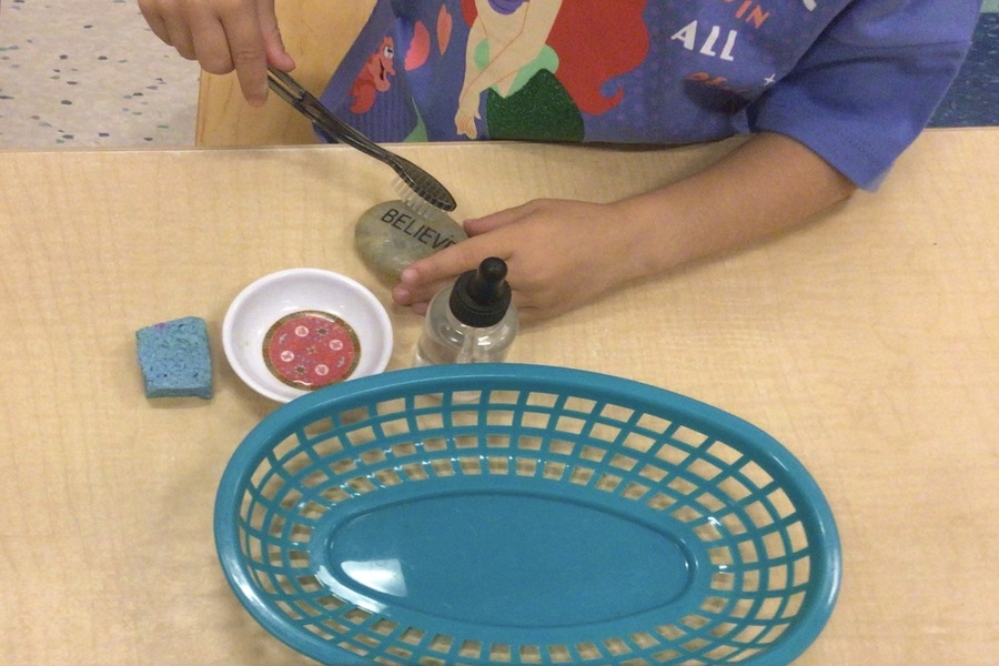 A child washing and brushing a rock