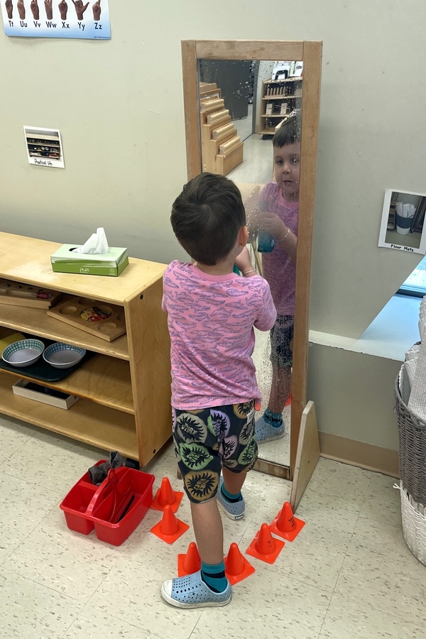 A child washing a mirror