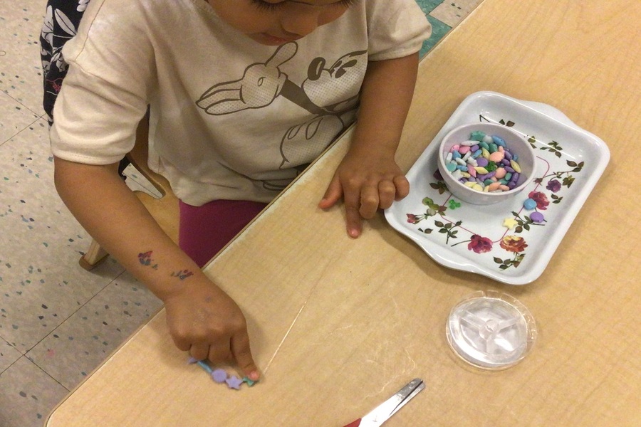 A child stringing beads