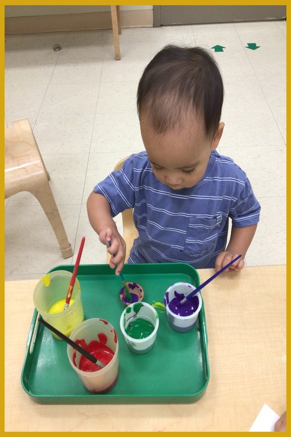 A child painting a diya lantern