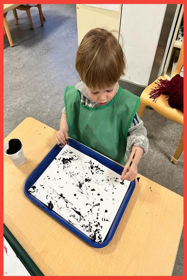 A child painting with chopsticks