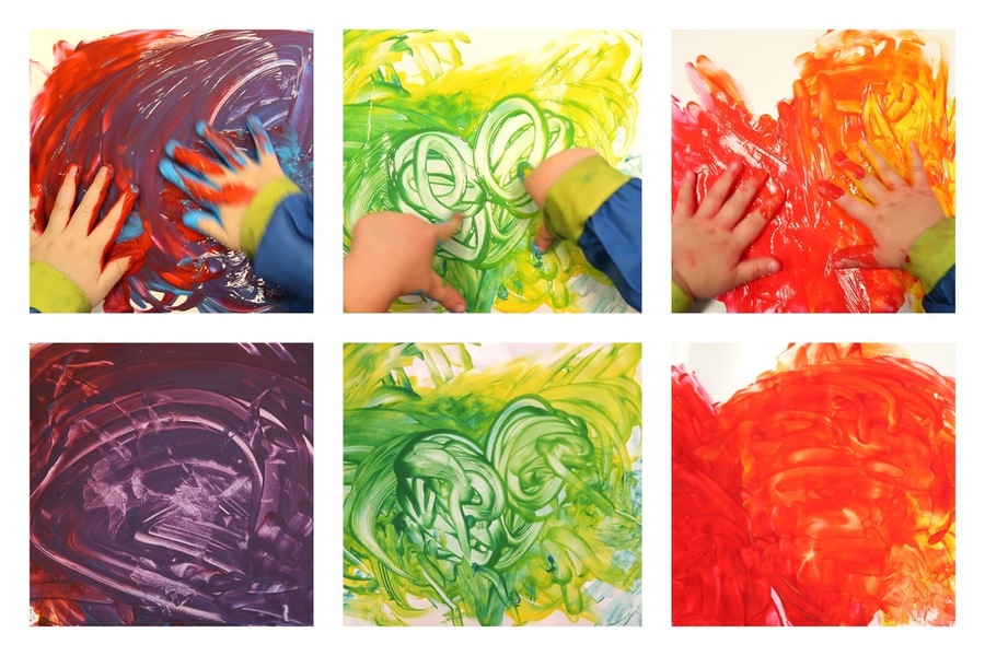 A child mixing colours through finger painting
