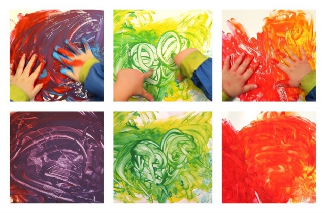 A child mixing colours through finger paintin