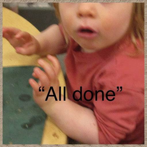 An infant signing 'all done'