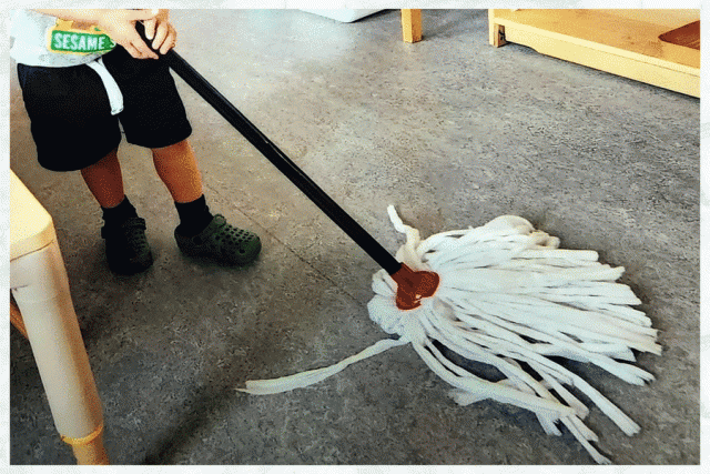 A child mopping a floor