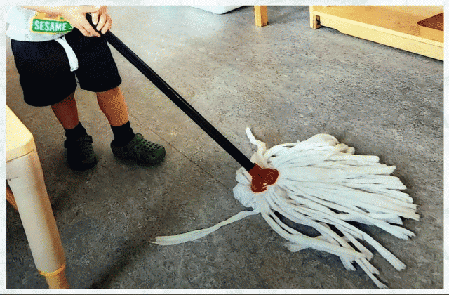 A child mopping a floor
