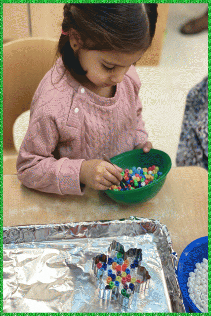 A child using tweezers to choose coloured pony beads
