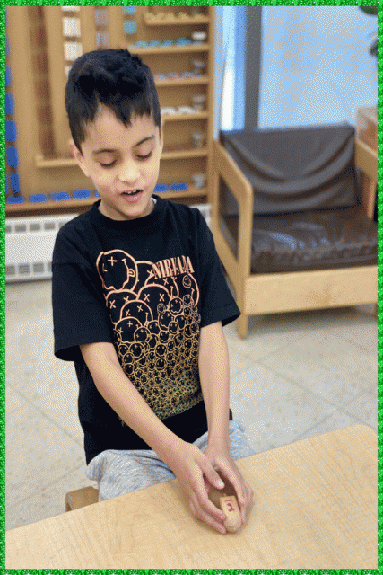 A child catching a spinning dreidel