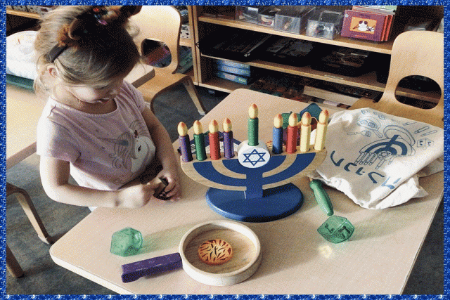 Children working with a menorah and latke set