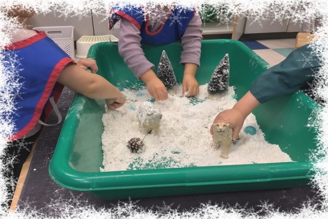 Children playing with snow dough, trees, pinecones and animals