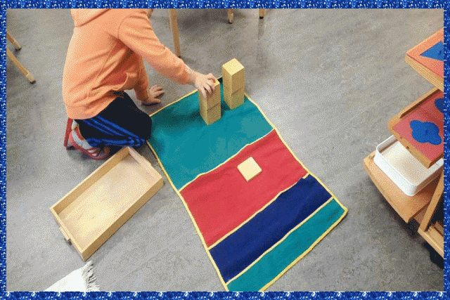 A child placing materials on a decimal placement mat