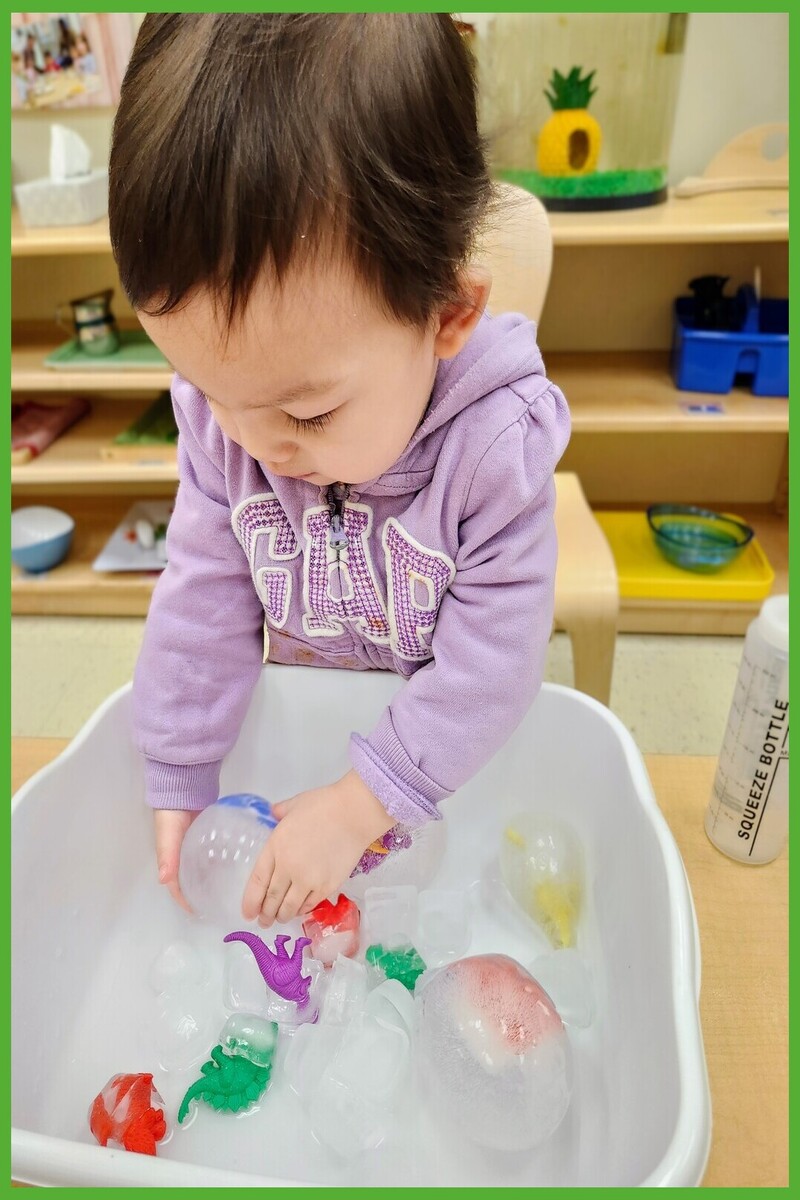 A child holding and feeling a dinosaur ice egg