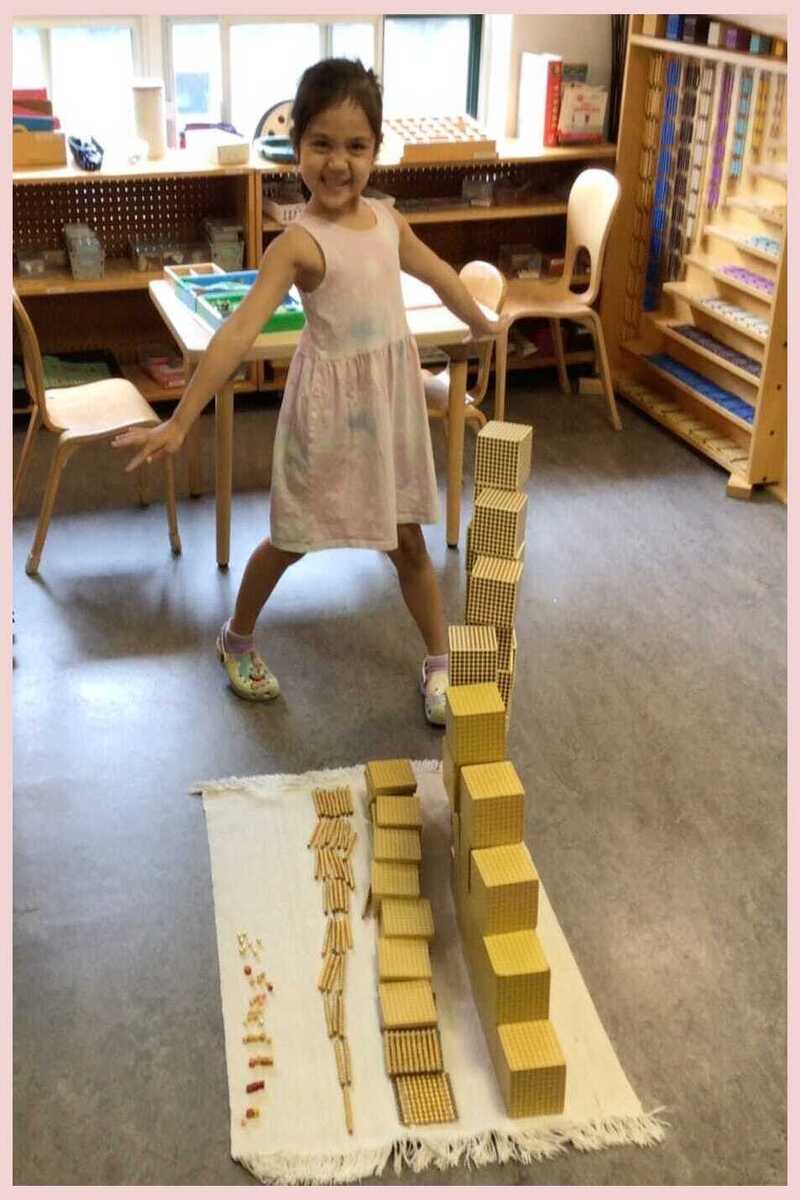 A child smiling and showing the Bird's Eye View she made