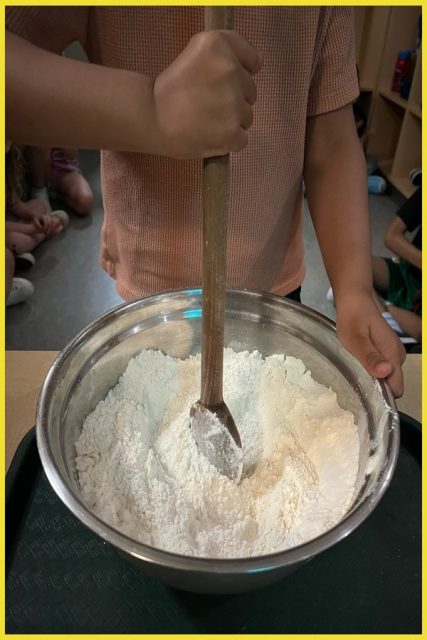 Stirring flour, salt and cream of tartar in a bowl