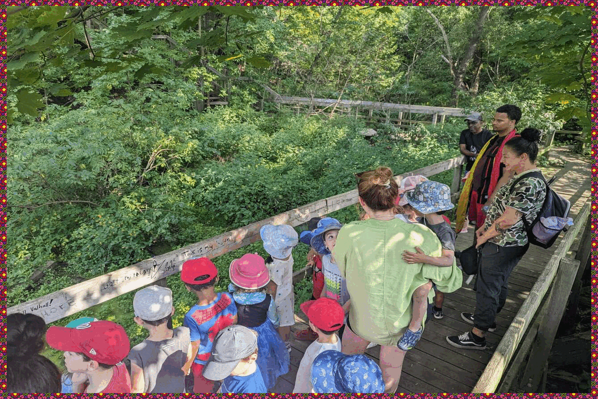 2 Casa groups standing on a bridge overlooking the woods