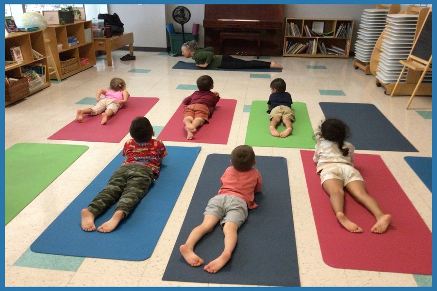 Children imitating Cheeba lying down and doing the 'Locust' or 'Salabhasana' pose