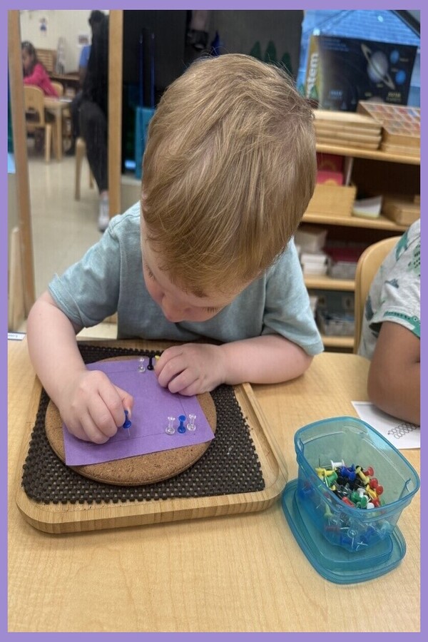 A child pricking holes in a square shape outline on a purple piece of paper.