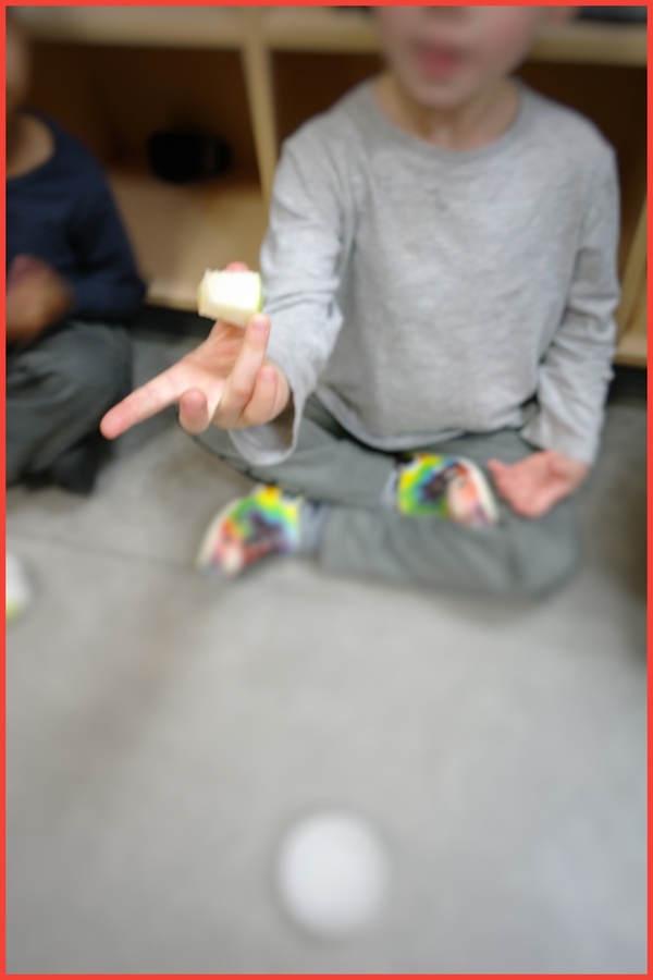 A child holding a piece of apple