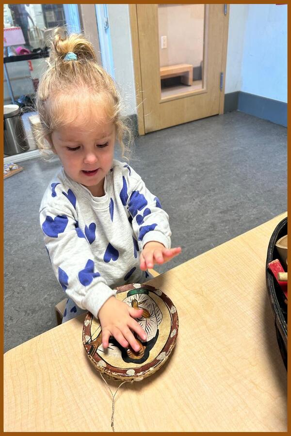 A child tapping on a drum